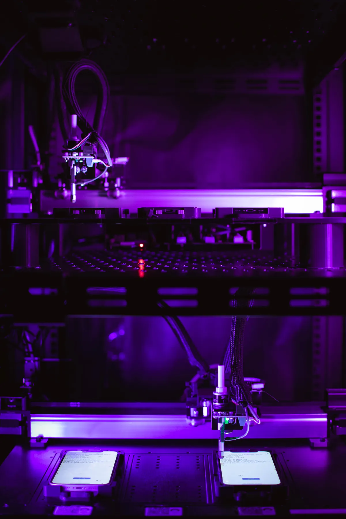 Two-tier robot rack with phones on illuminated stages